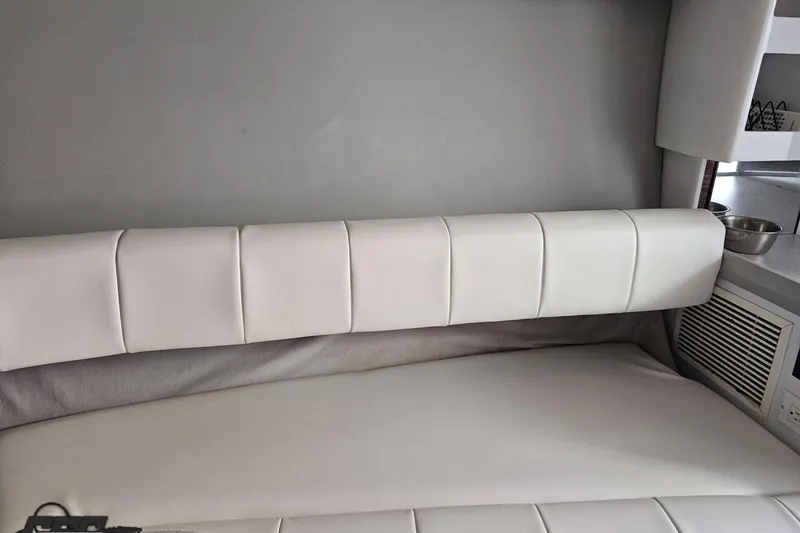 Slide: The Image of Interior of a 1997 Formula 382 FASTech boat with white cushioned seating. - 84