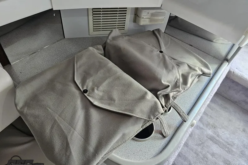 Slide: The Image of Interior of a 1997 Formula 382 FASTech boat with gray cushions and storage area. - 88