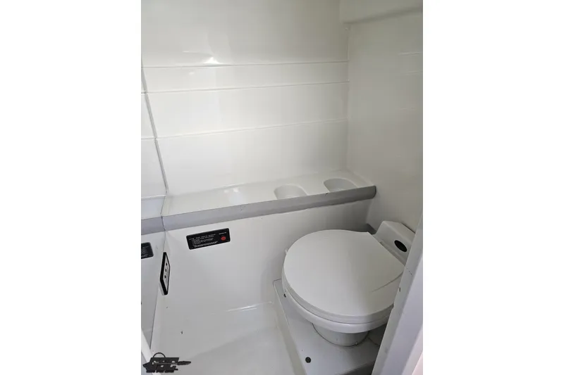 Slide: The Image of 1997 Formula 382 FASTech boat bathroom with white interior and compact toilet. - 90