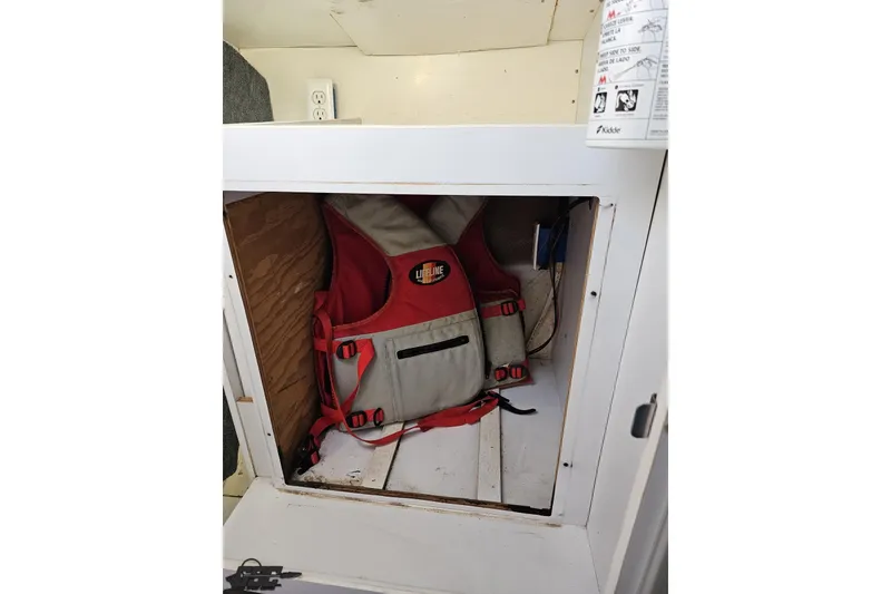 Slide: The Image of Red life jacket stored in a compartment of a 1997 Formula 382 FASTech boat. - 91