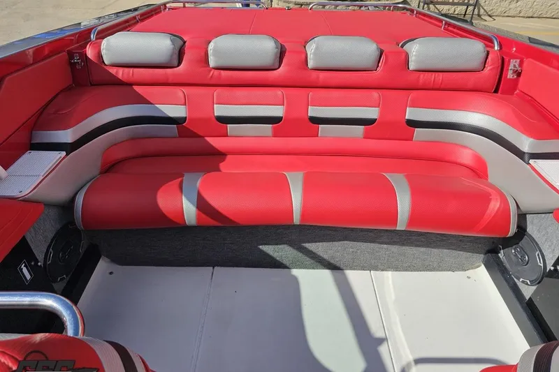 Slide: The Image of Red and gray interior of a 1997 Formula 382 FASTech boat, featuring cushioned seating. - 98
