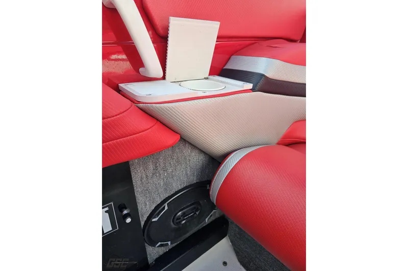 Slide: The Image of Red and gray interior of a 1997 Formula 382 FASTech boat, featuring a speaker and cup holder. - 99