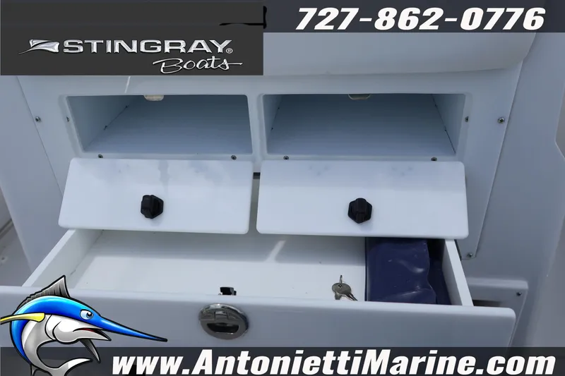 Slide: The Image of 2026 Stingray 253 CC boat storage compartments with contact details and website. - 12