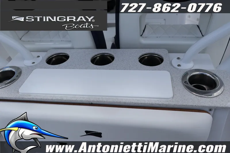 Slide: The Image of 2026 Stingray 253 CC boat console with cup holders and cutting board, Antonietti Marine branding. - 13