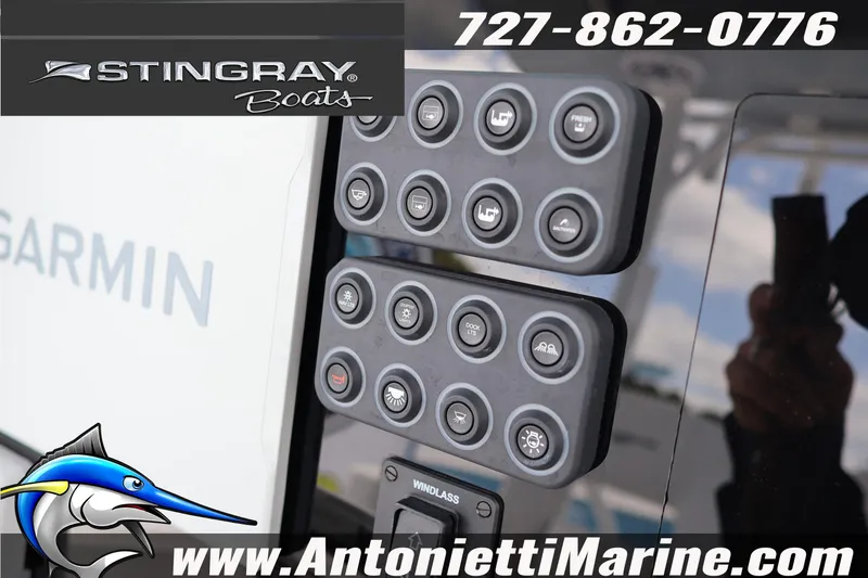Slide: The Image of Control panel of 2026 Stingray 253 CC boat with Garmin display and contact details. - 18