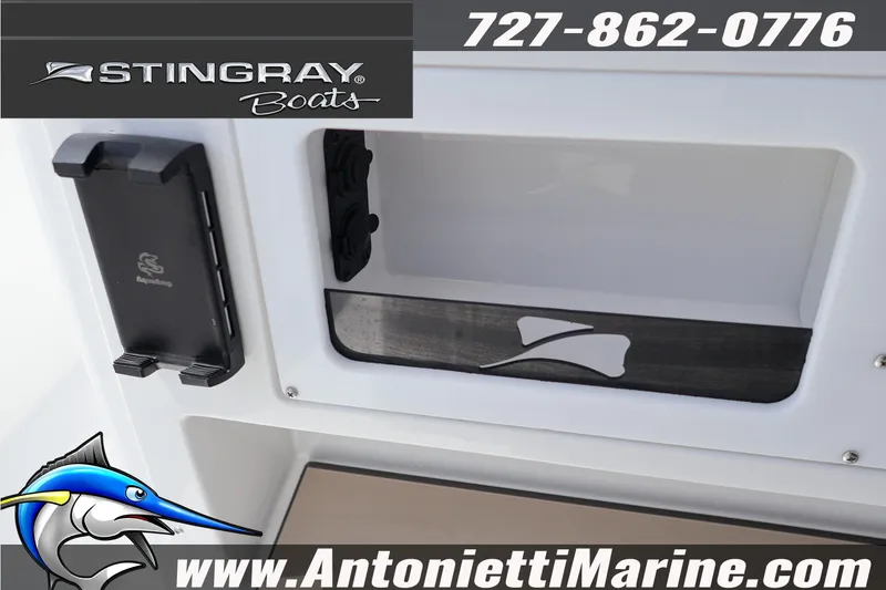 Slide: The Image of 2026 Stingray 253 CC boat detail with logo and contact information. - 19