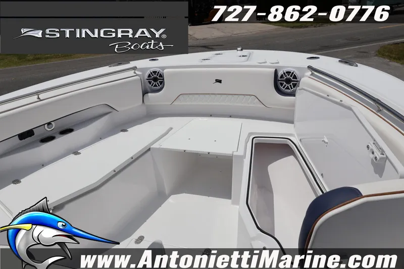 Slide: The Image of 2026 Stingray 253 CC boat interior with seating and storage, featuring marine speakers. - 24