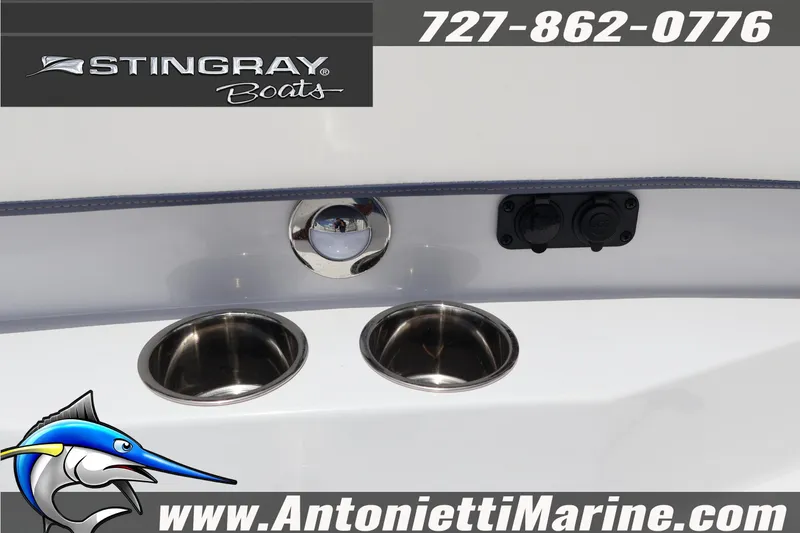 Slide: The Image of 2026 Stingray 253 CC boat detail with cup holders and contact information. - 25