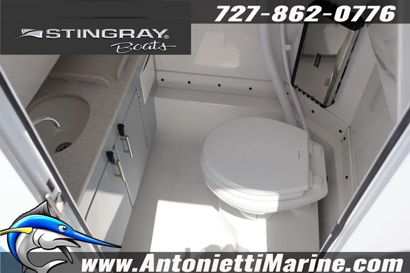 Slide: The Image of 2026 Stingray 253 CC boat interior with sink and toilet, featuring marine amenities. - 32