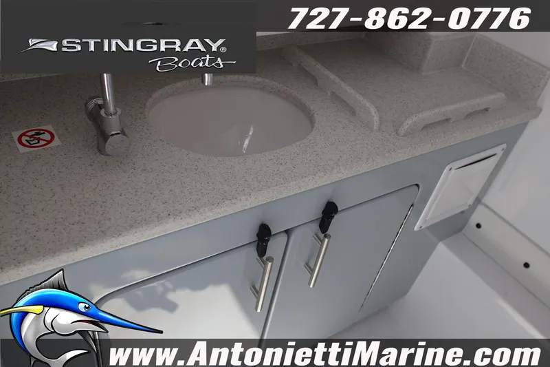 Slide: The Image of 2026 Stingray 253 CC boat interior with sink and storage, featuring Antonietti Marine branding. - 33