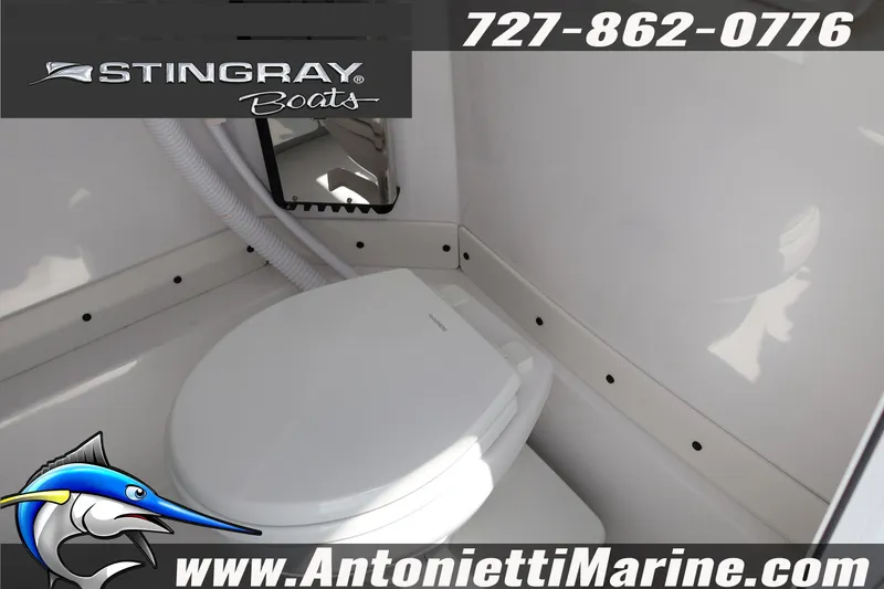 Slide: The Image of 2026 Stingray 253 CC boat interior with marine toilet, featuring sleek design and functionality. - 34