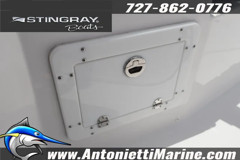 Slide: The Image of 2026 Stingray 253 CC boat compartment with logo and contact details. - 37