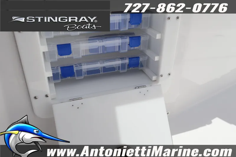 Slide: The Image of Stingray 253 CC 2026 boat storage compartment with tackle boxes, Antonietti Marine branding. - 38