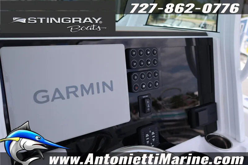 Slide: The Image of 2026 Stingray 253 CC boat dashboard featuring Garmin navigation system and control panel. - 39