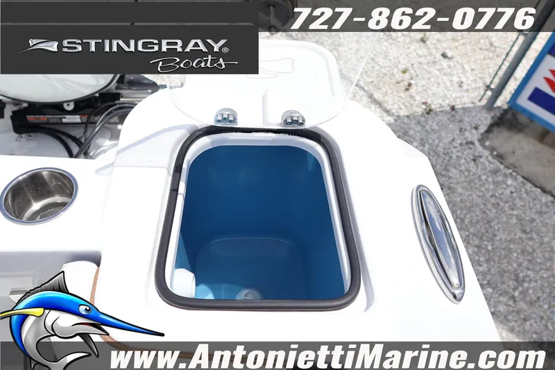 Slide: The Image of 2026 Stingray 253 CC boat with open storage compartment, displayed at Antonietti Marine. - 43