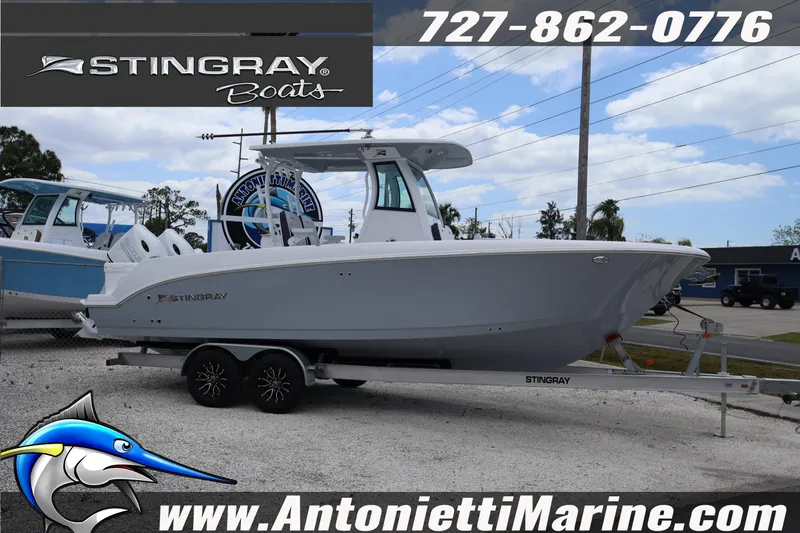 Slide: The Image of 2026 Stingray 253 CC boat on trailer at Antonietti Marine dealership. - 5
