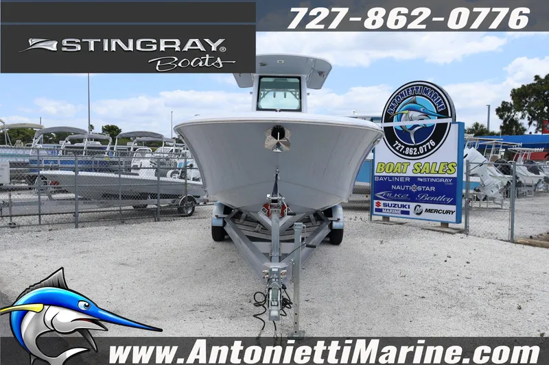 Slide: The Image of 2026 Stingray 253 CC boat on trailer at Antonietti Marine sales lot. - 6