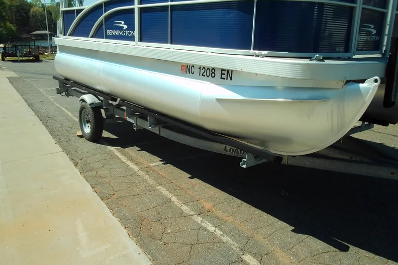 Slide: The Image of 2020 Bennington SV 188 SLV pontoon boat on trailer, parked outdoors. - 19