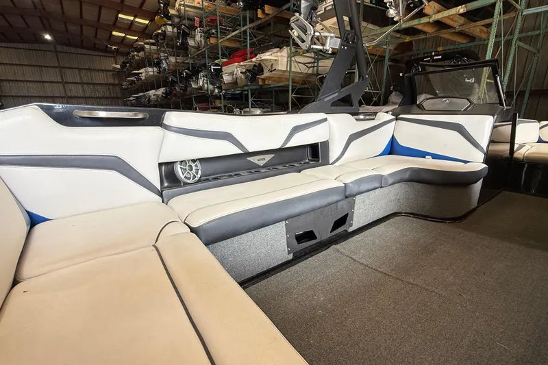 Slide: The Image of Interior of a 2015 Axis T23 boat with white and gray seating. - 10