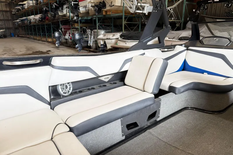 Slide: The Image of Interior of a 2015 Axis T23 boat with white and gray seating. - 11