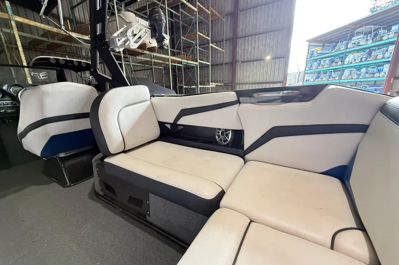 Slide: The Image of Interior of a 2015 Axis T23 boat with white and black seating. - 12