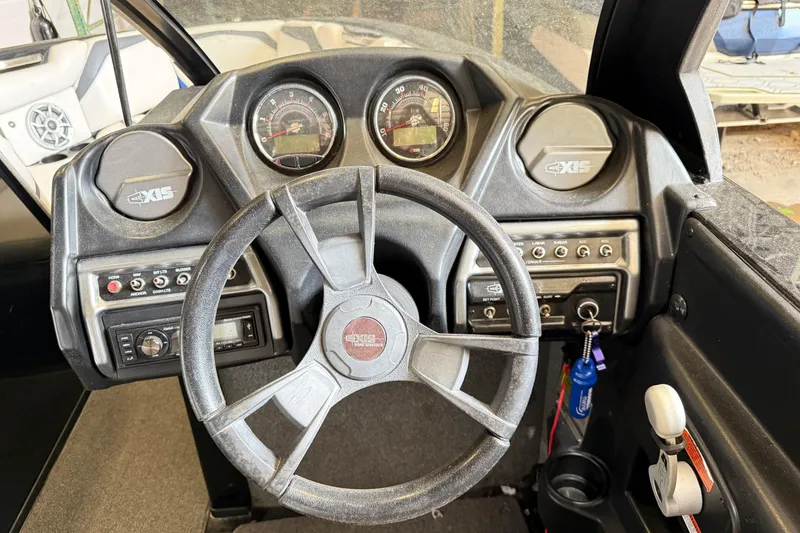 Slide: The Image of 2015 Axis T23 boat dashboard with steering wheel and control panel. - 14