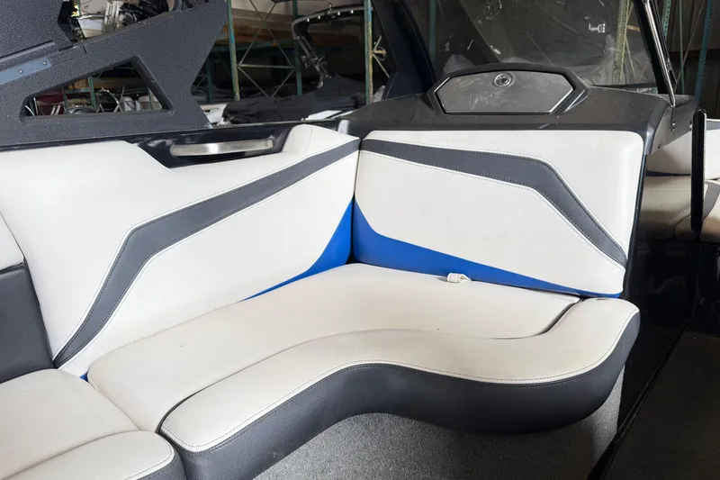 Slide: The Image of Interior seating of a 2015 Axis T23 boat with white, blue, and gray upholstery. - 15
