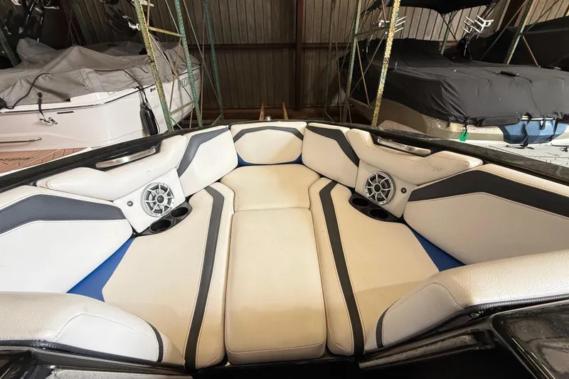 Slide: The Image of Interior of a 2015 Axis T23 boat with cushioned seating and speakers. - 16