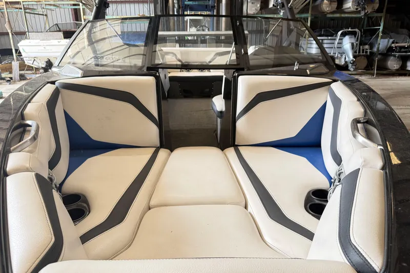 Slide: The Image of Interior of a 2015 Axis T23 boat with stylish seating and cup holders. - 17