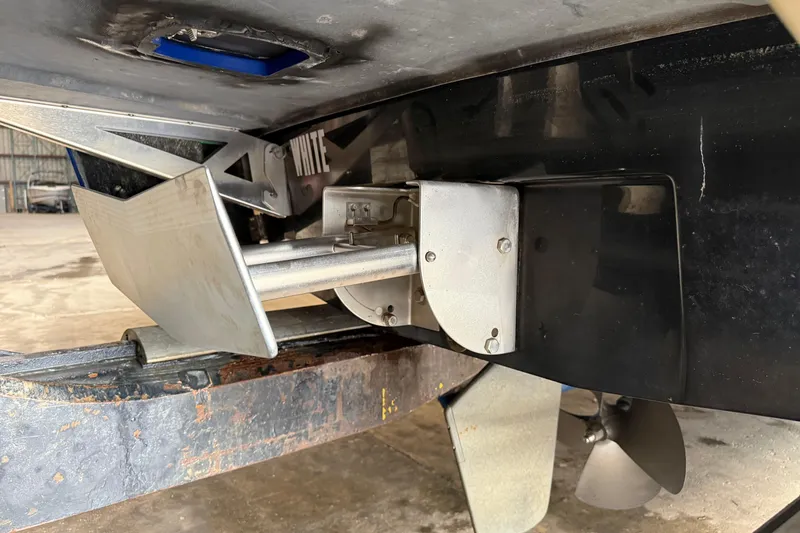 Slide: The Image of Close-up of 2015 Axis T23 boat propeller and rudder system in a garage. - 22