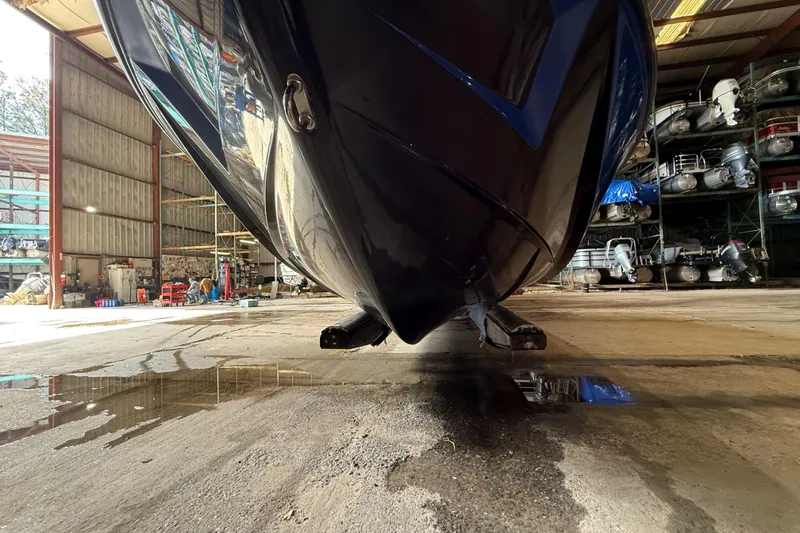 Slide: The Image of 2015 Axis T23 boat in storage facility, reflecting on wet concrete floor. - 24