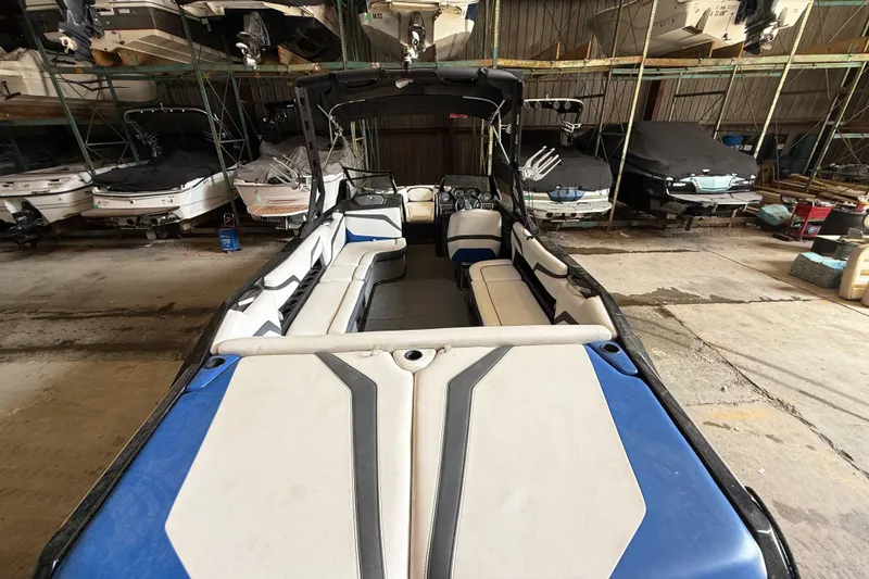 Slide: The Image of 2015 Axis T23 boat with blue and white interior in storage facility. - 7