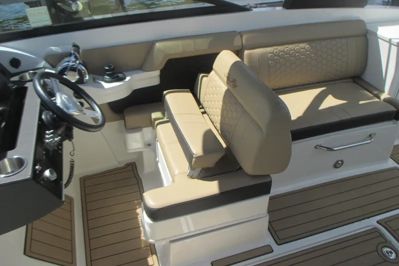 Slide: The Image of 2019 Sea Ray 290 SLX boat interior with beige seating and steering wheel. - 10