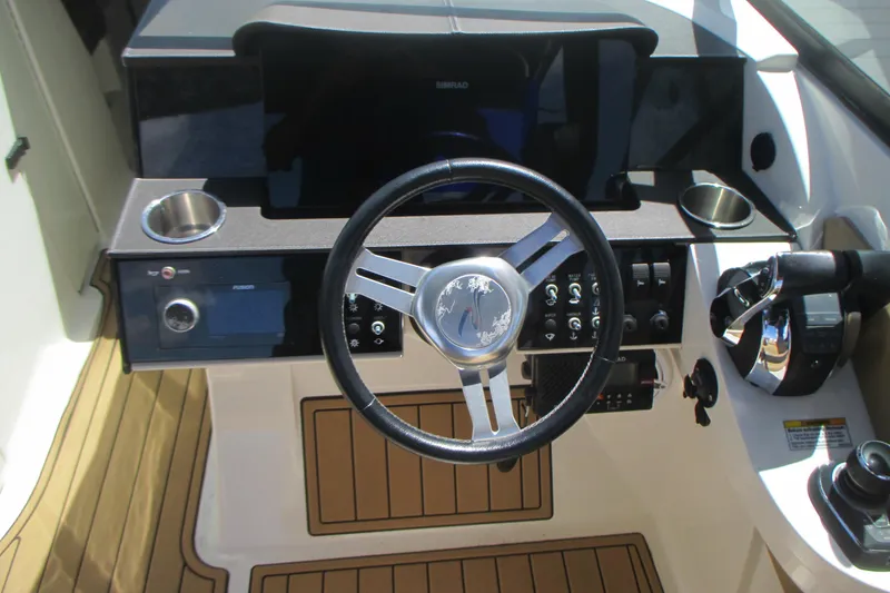 Slide: The Image of 2019 Sea Ray 290 SLX boat dashboard with steering wheel and control panel. - 11