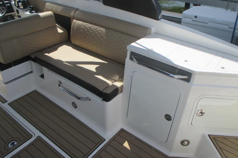 Slide: The Image of 2019 Sea Ray 290 SLX interior with beige seating and white cabinetry. - 12