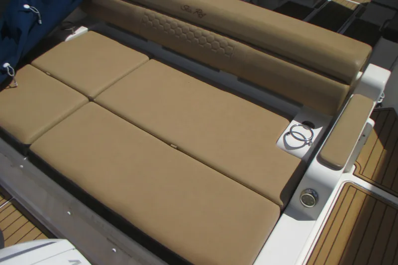 Slide: The Image of 2019 Sea Ray 290 SLX boat with tan cushioned seating and teak flooring. - 2