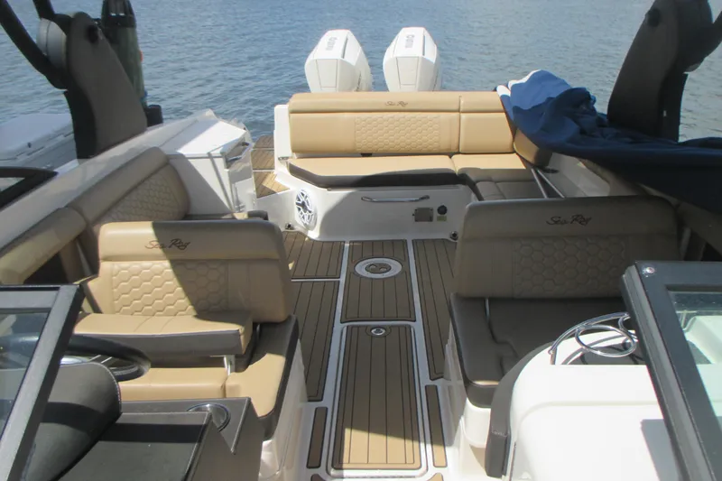 Slide: The Image of 2019 Sea Ray 290 SLX boat interior with tan seating and wood flooring. - 3