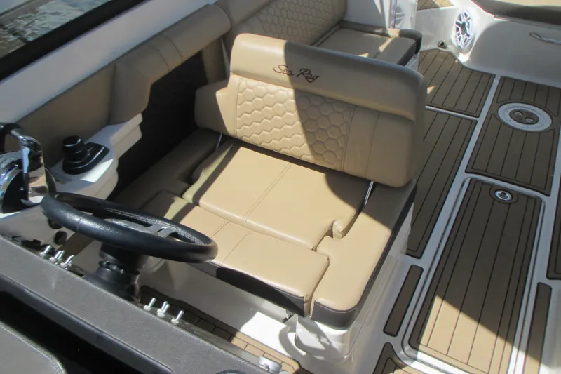 Slide: The Image of 2019 Sea Ray 290 SLX boat interior with tan seating and steering wheel. - 4