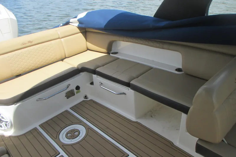 Slide: The Image of 2019 Sea Ray 290 SLX boat interior with tan seating and wood-style flooring. - 6