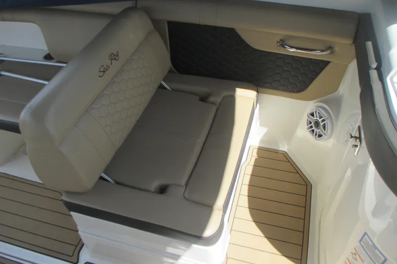 Slide: The Image of 2019 Sea Ray 290 SLX boat interior with beige seating and wood-style flooring. - 8