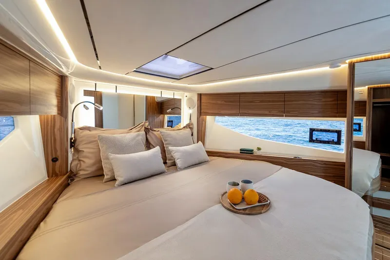 Slide: The Image of Manufacturer Provided Image: Luxurious cabin interior of 2025 Marex 390 yacht with elegant wood finish and ocean view. - 12