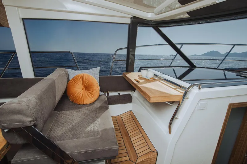 Slide: The Image of Manufacturer Provided Image: Luxurious interior of 2025 Marex 390 yacht with ocean view and cozy seating. - 8