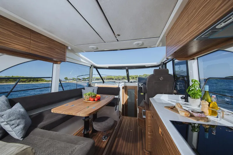 Slide: The Image of Manufacturer Provided Image: Luxurious interior of 2025 Marex 390 yacht with modern kitchen and dining area. - 9