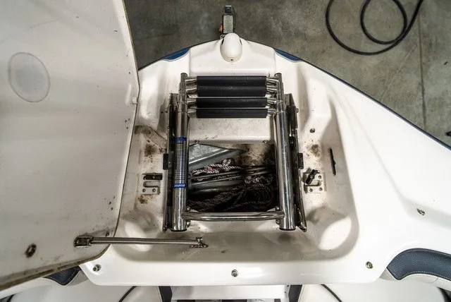 Slide: The Image of An open storage compartment on a Yamaha SX210 boat with a ladder and ropes. - 22