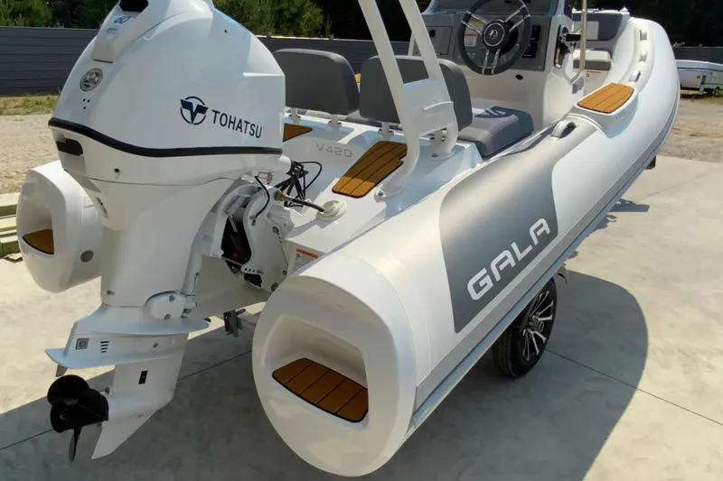 The Image of 2027 Gala V420 inflatable boat with Tohatsu engine, featuring sleek design and modern seating. - 1