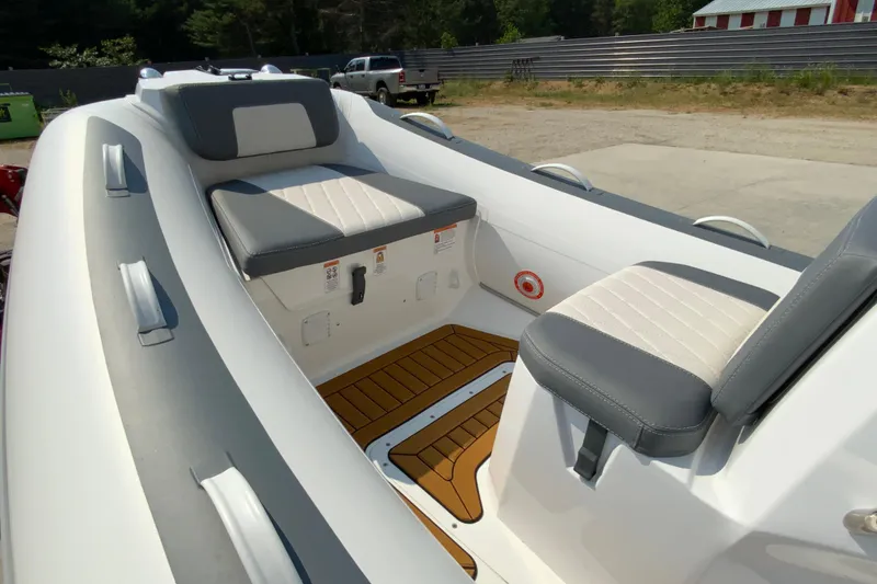 Slide: The Image of 2027 Gala V420 boat interior with cushioned seating and teak-style flooring. - 6