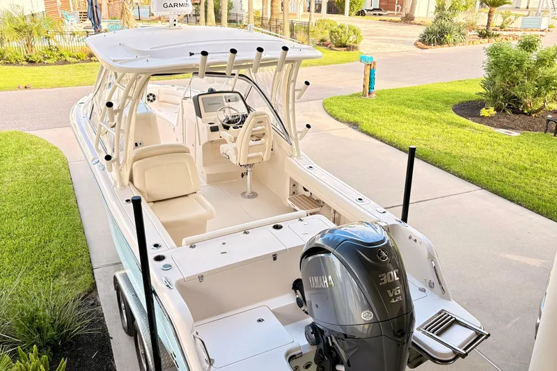 The Image of 2022 Grady-White Freedom 235 boat with Yamaha 300 engine, parked on driveway. - 0