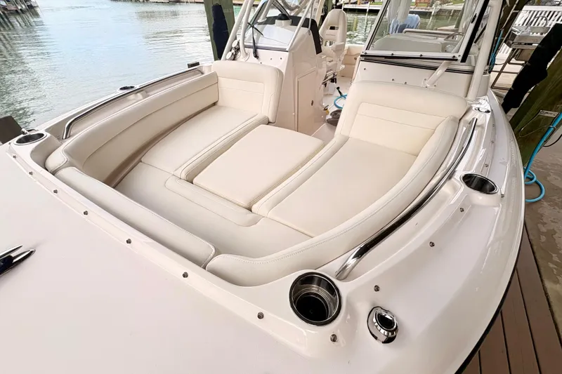 Slide: The Image of 2022 Grady-White Freedom 235 boat interior with plush seating and cup holders. - 13