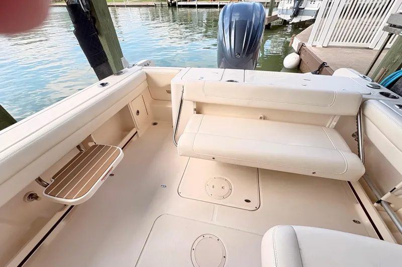 Slide: The Image of 2022 Grady-White Freedom 235 boat interior with seating and water view. - 6
