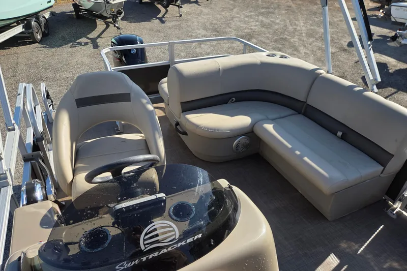 Slide: The Image of 2022 Sun Tracker Party Barge 18 DLX interior with seating and steering console. - 12